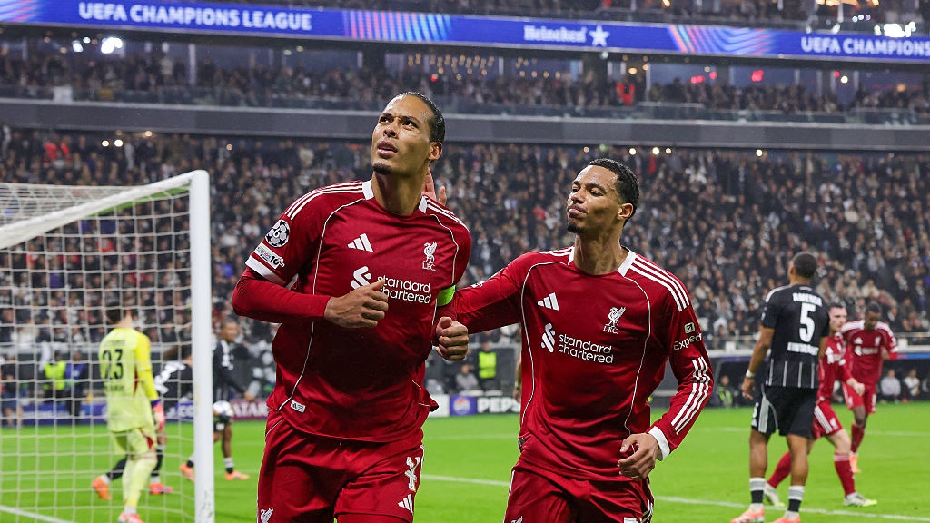 Virgil van Dijk of Liverpool FC (L) celebrates with teammate Hugo Ekitike after scoring his team's second goal during the UEFA Champions League 2025/26 League Phase MD3 match between Eintracht Frankfurt and Liverpool FC at Frankfurt Stadion on October 22, 2025 in Frankfurt am Main, Germany.