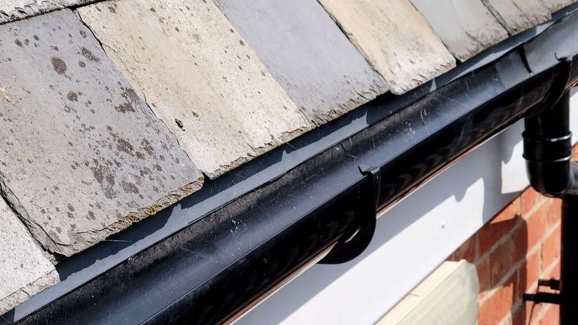 New black guttering on white fascia board with slate roof tiles