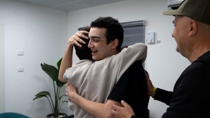 U.S.-Israeli hostage Edan Alexander hugs his family after release by Hamas