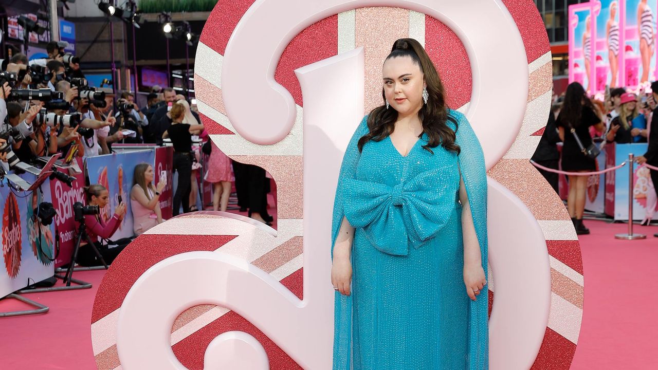 An image of Sharon Rooney wearing a magnificent blue gown on the pink red carpet for the Barbie Premiere in London