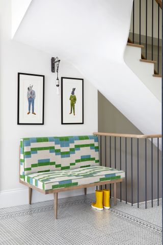 White hallway with green and white sofa
