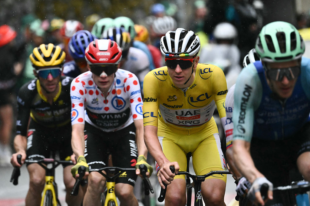 Team Visma - Lease a bike team's Danish rider Jonas Vingegaard wearing the best climber's polka dot (dotted) jersey (center L) and UAE Team Emirates - XRG team's Slovenian rider Tadej Pogacar wearing the overall leader's yellow jersey (center R) cycle in the final ascent of La Plagne during the 19th stage of the 112th edition of the Tour de France cycling race, 93.1 km between Albertville and La Plagne, in the French Alps, on July 25, 2025. The 19th stage of the Tour de France was shorted from its initial 129.9 km route, bypassing the Col des Saisies where an outbreak of nodular dermatitis in a herd of cattle was discovered, prompting organizers to modify the race route. (Photo by Marco BERTORELLO / AFP) (Photo by MARCO BERTORELLO/AFP via Getty Images)