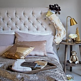 Bedroom with sequin cushion, glittery throw and golden Christmas stocking