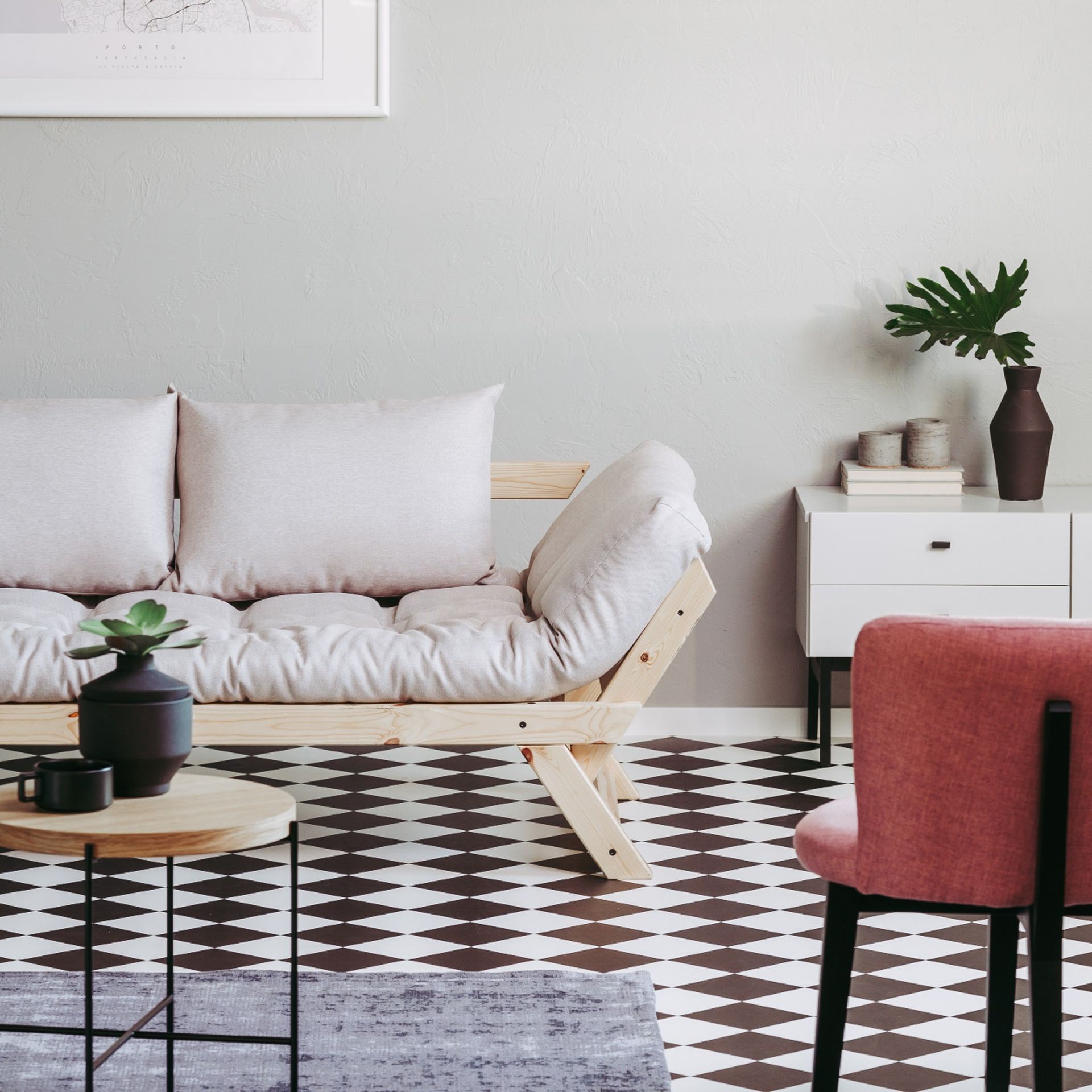 Neutral futon bed in living room, coffee table, side table