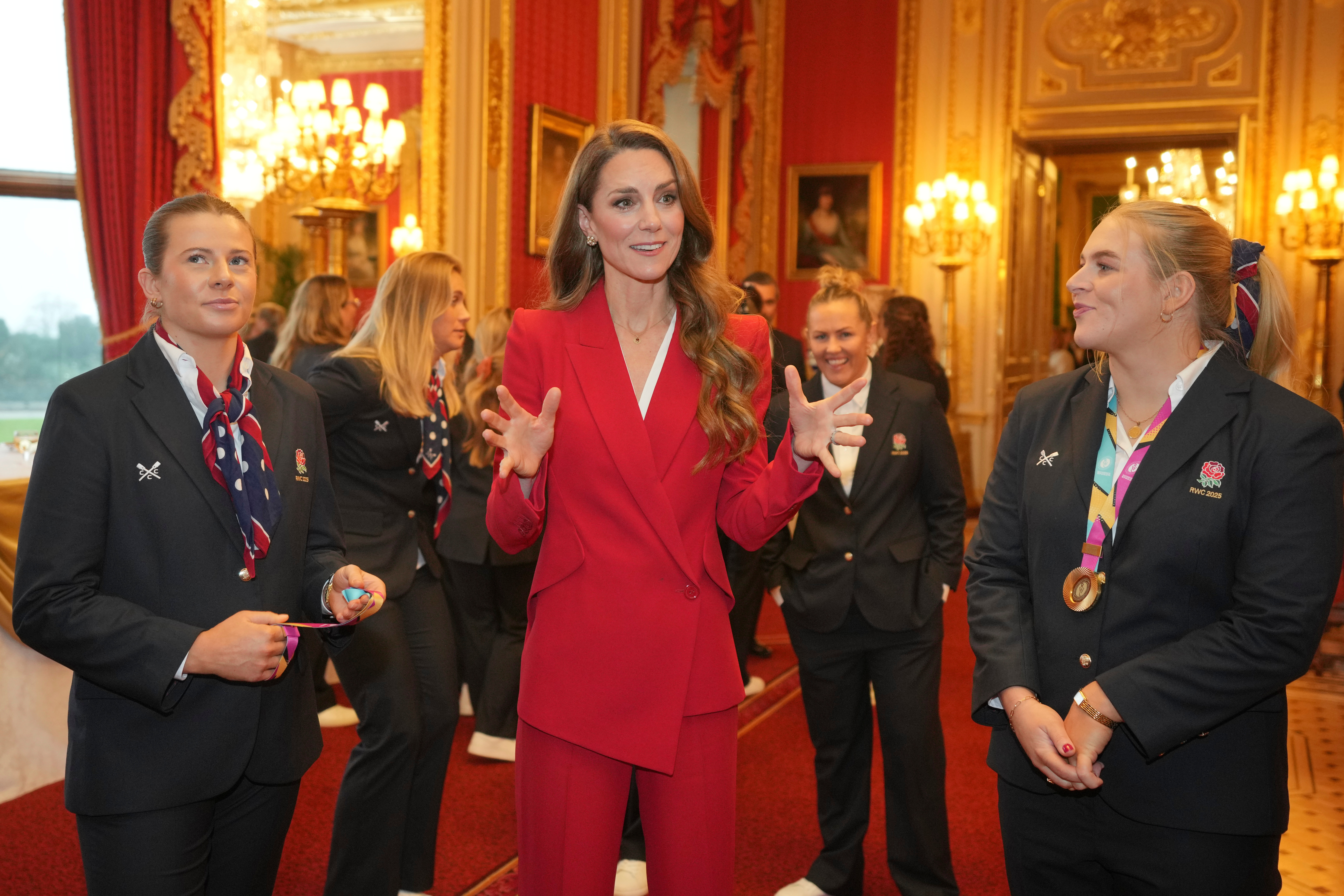 Britain's Kate, Princess of Wales, gestures as she speaks to members of the England Women's rugby team