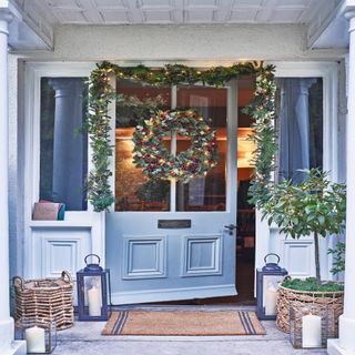 Christmas wreath drapes around a front door
