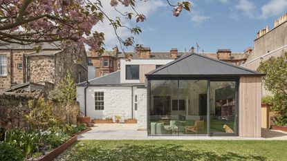 exterior of a traditional listed property with a contemporary kitchen extension