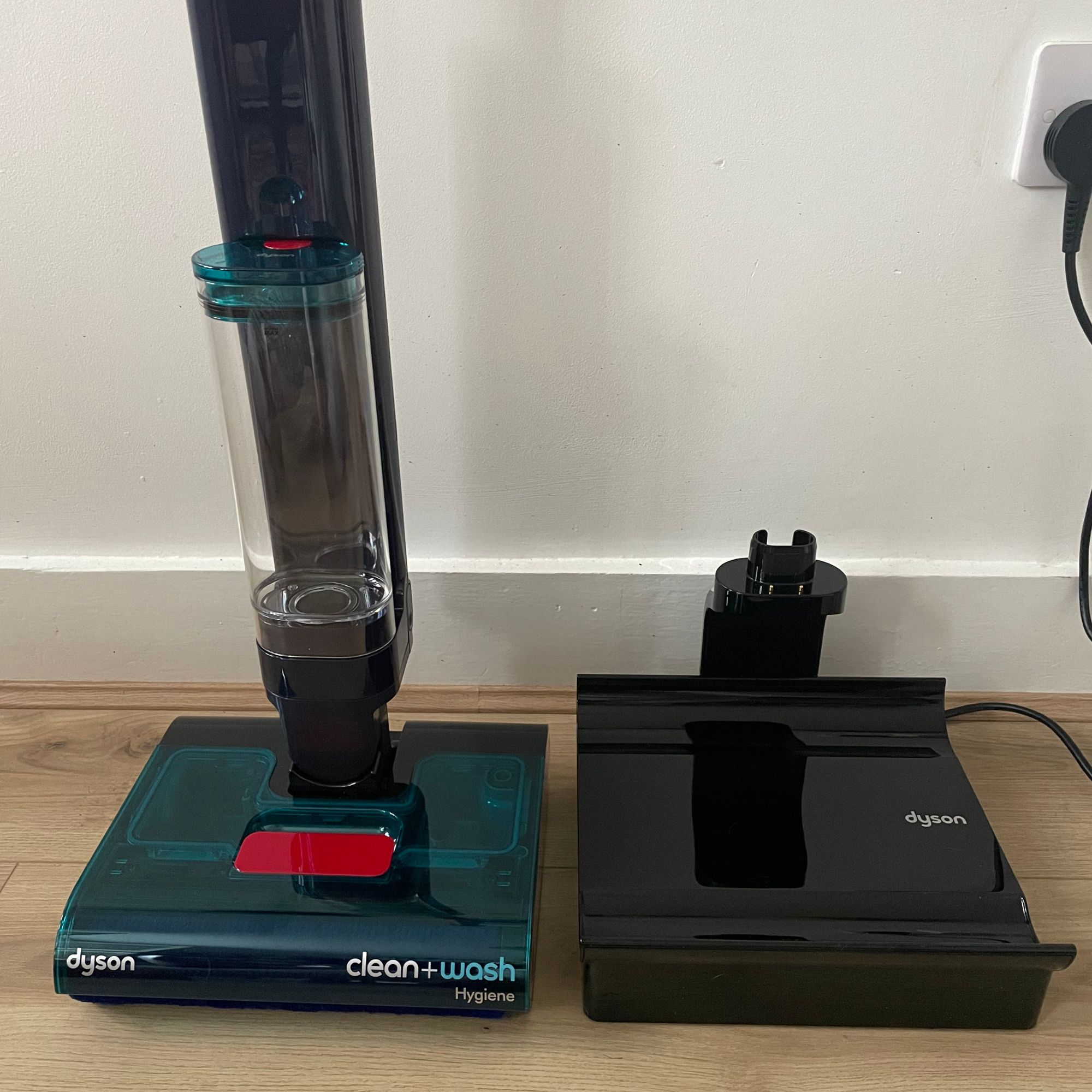 Dyson Clean+Wash Hygiene floorhead next to the hot air drying dock