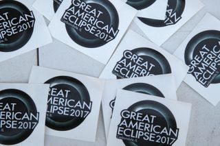 A vendor sells solar eclipse stickers in Carbondale on Aug. 19, 2017.