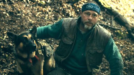 Brad Pitt is shown as James Belmont and canine actor Uber is shown as Odin in Heart of the Beast.