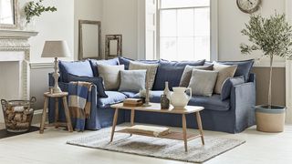 living room with blue corner sofa and wooden coffee table