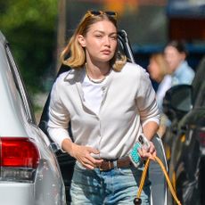 Gigi Hadid wearing a white cardigan and jeans