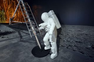 A 3-D printed, life-size statue of Neil Armstrong in his spacesuit stands near a replica of the Apollo 11 plaque that bears President Richard Nixon's signature on the moon in "Apollo 11: One Giant Leap for Mankind" at the Richard Nixon Presidential Library and Museum.