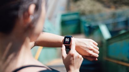 Woman checking her heart rate on a smartwatch