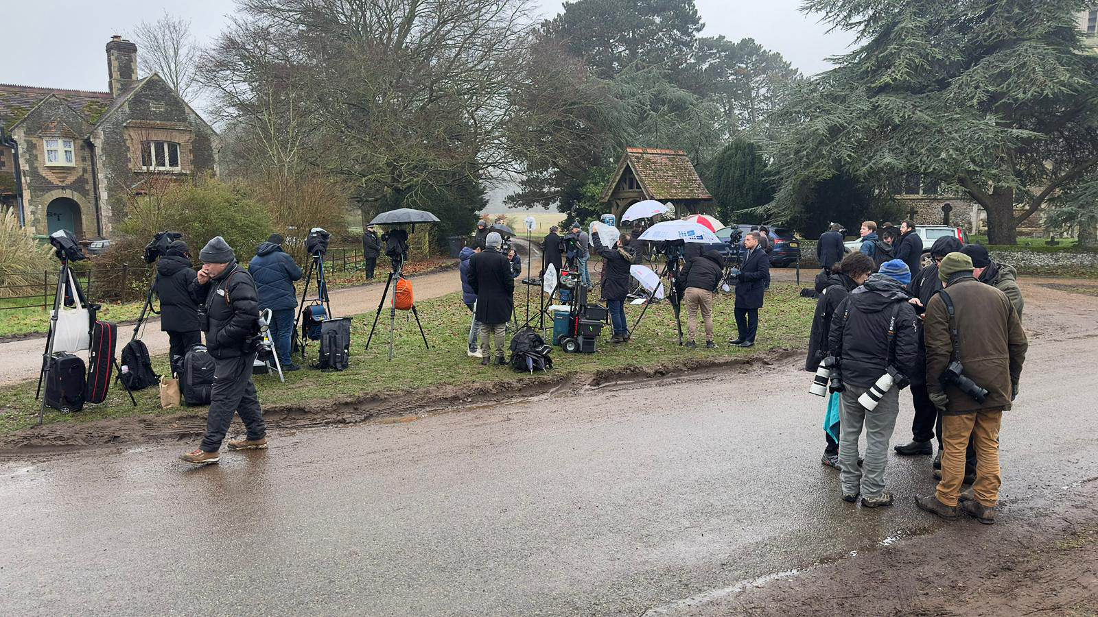 Press gathered at the entrance to Wood Farm
