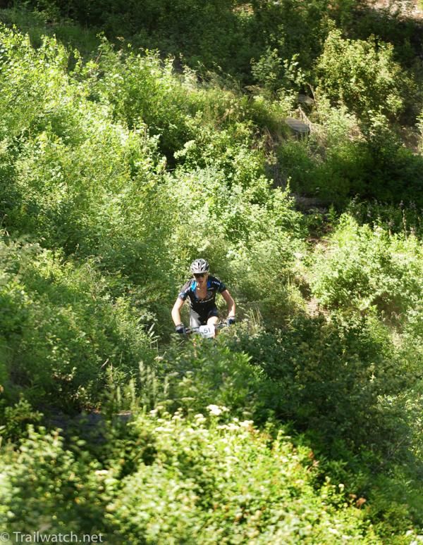 Russell Finsterwald (Subaru-Trek) rides downhill singletrack so narrow that you could not see the trail
