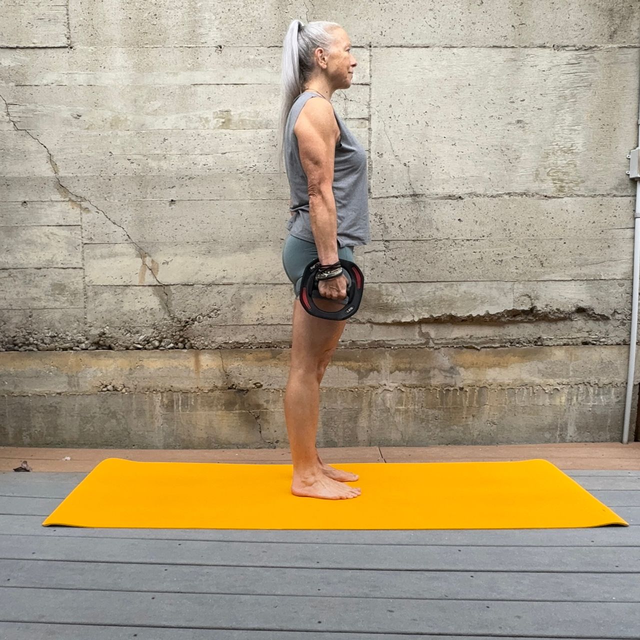 Woman exercising with weight plate