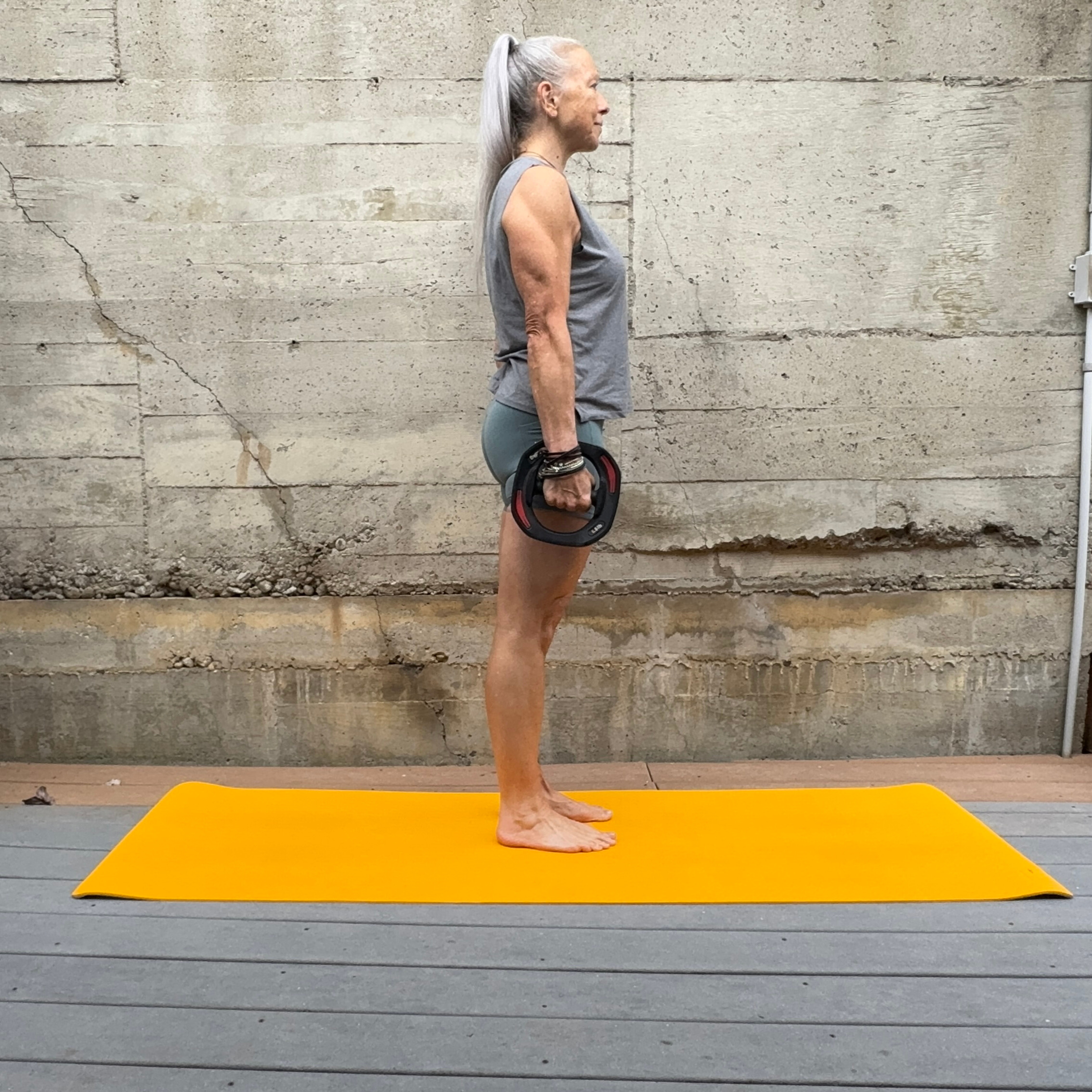 Woman exercising with weight plate