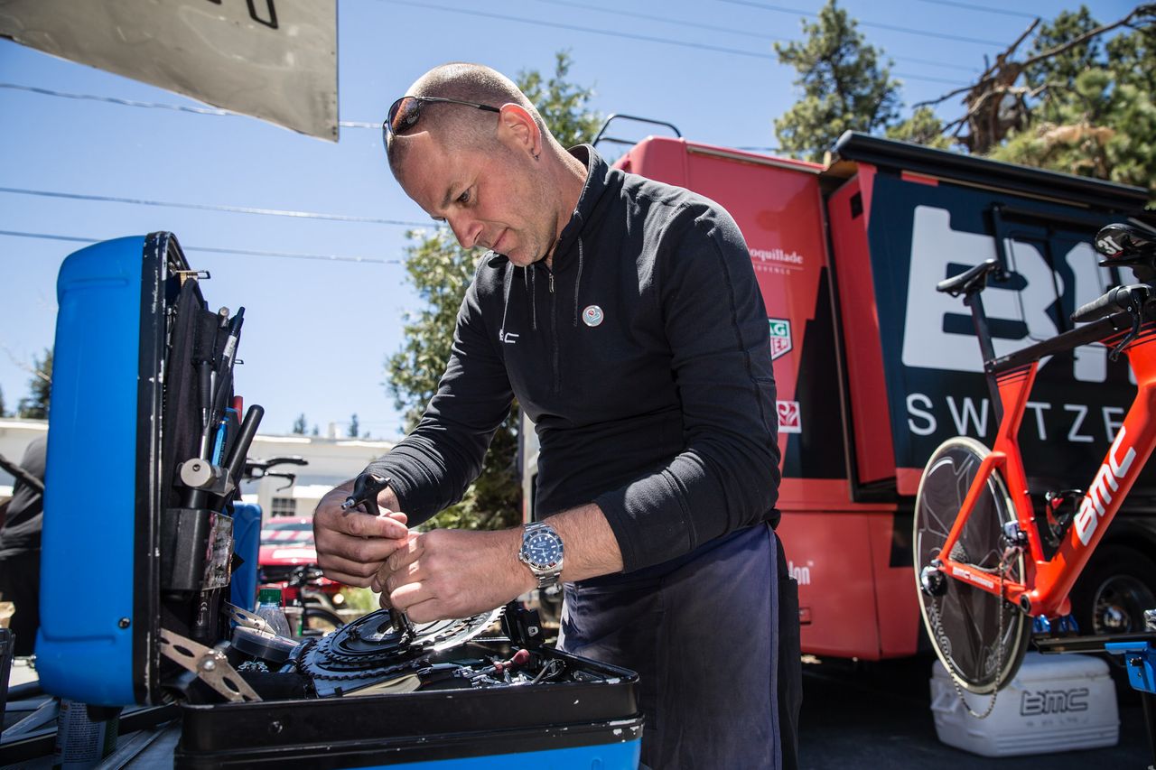 A BMC Racing mechanic adjust chainrings on a crankset