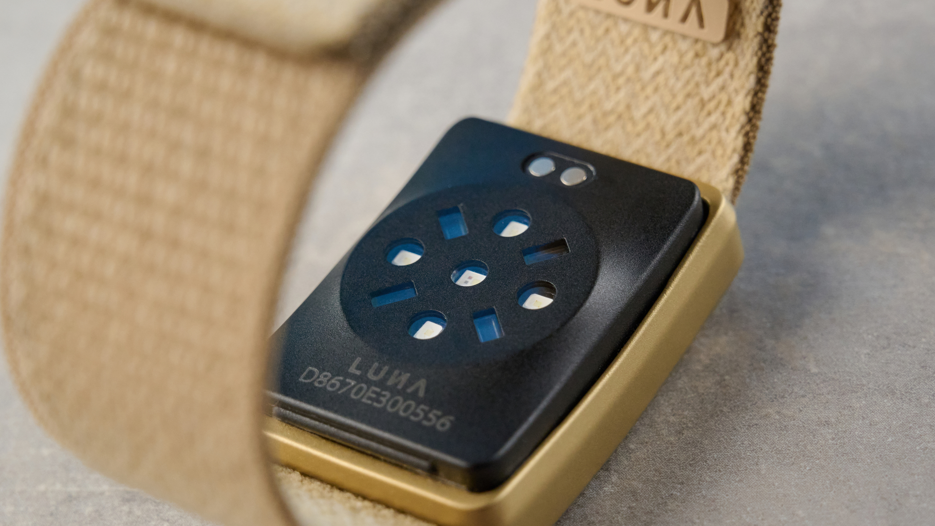 the luna band in beige photographed with the blue tom's guide background being worn by the author