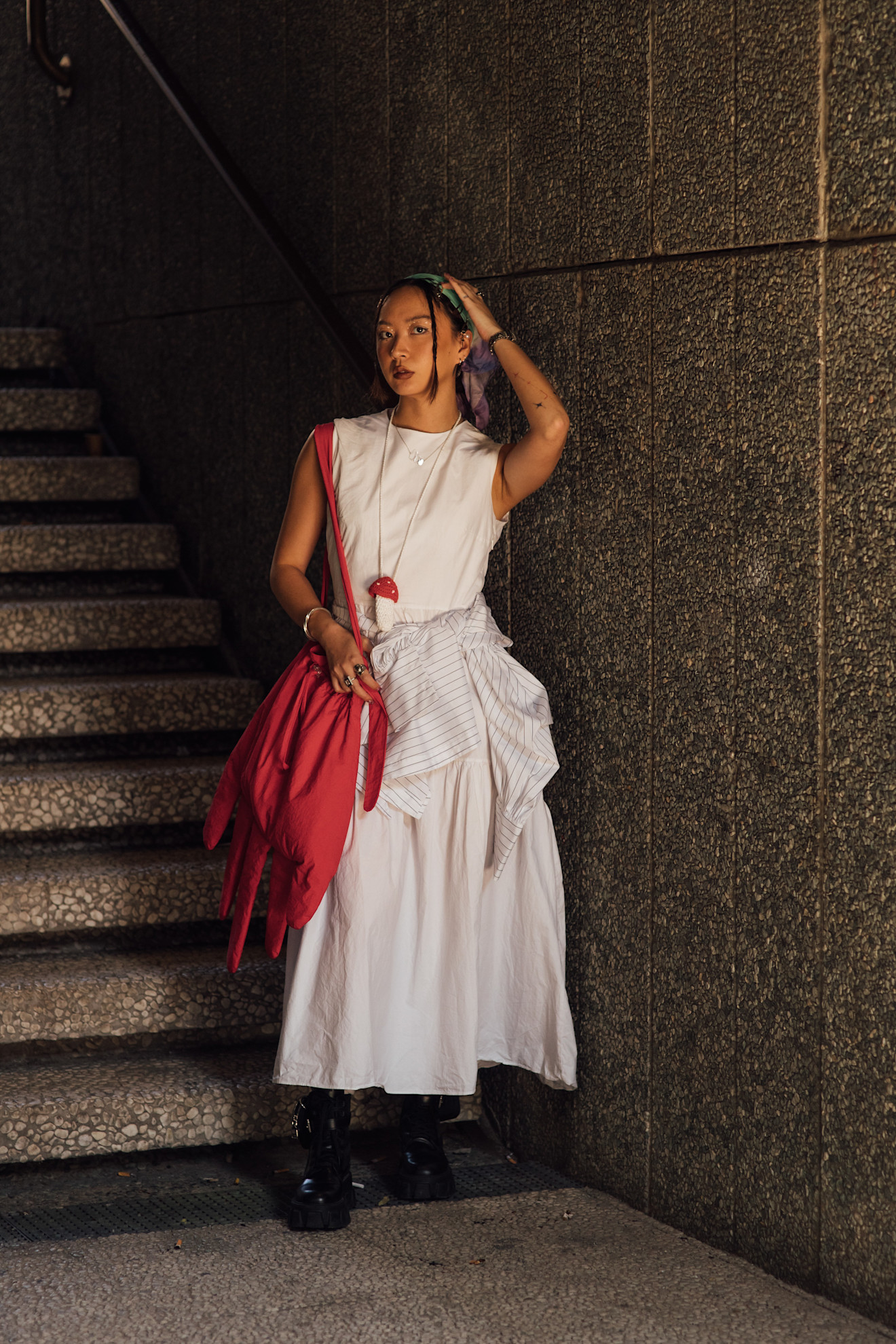 Milan Mens Fashion Week Showgoer wears a headscarf over her hair outside on the streets in Milan.