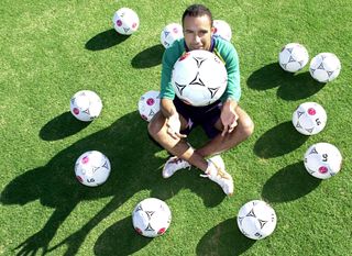 Australia's Archie Thompson poses with 13 balls after scoring 13 goals in a 31-0 win over American Samoa in April 2001.