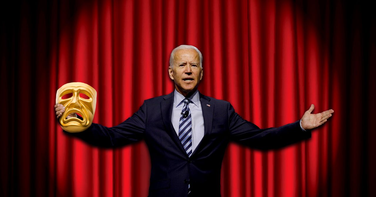 Former Vice President Joe Biden holds a tragedy mask on a stage.