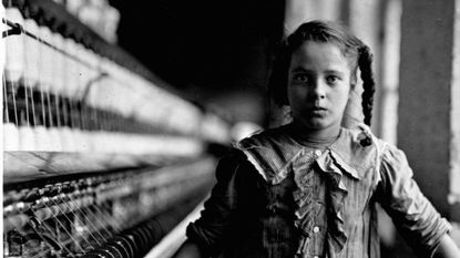 A girl works on spinning machines nearly a century ago in the US