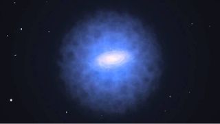 a blue haze surrounds a galaxy in the black of space