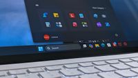 A Lenovo Yoga Slim 7i Ultra (Gen 11) Aura Edition laptop screen shows a home screen with open taskbar featuring app icons.