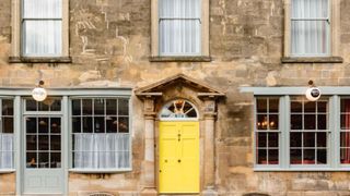 exterior of Number One Bruton with bright yellow door