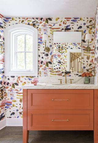 A bathroom with red vanity