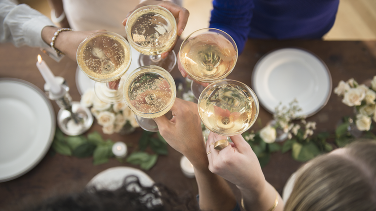 cheapest supermarket champagne and prosecco deals - group with their glasses
