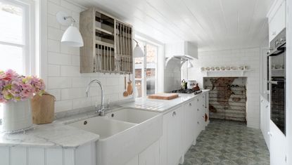 narrow kitchen with orange fridge