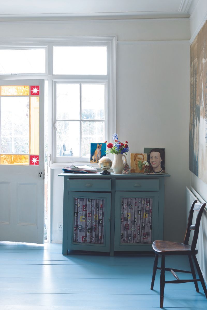 entry space with chest of drawers and artwork