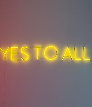 yellow neon artwork spelling 'Yes to all'