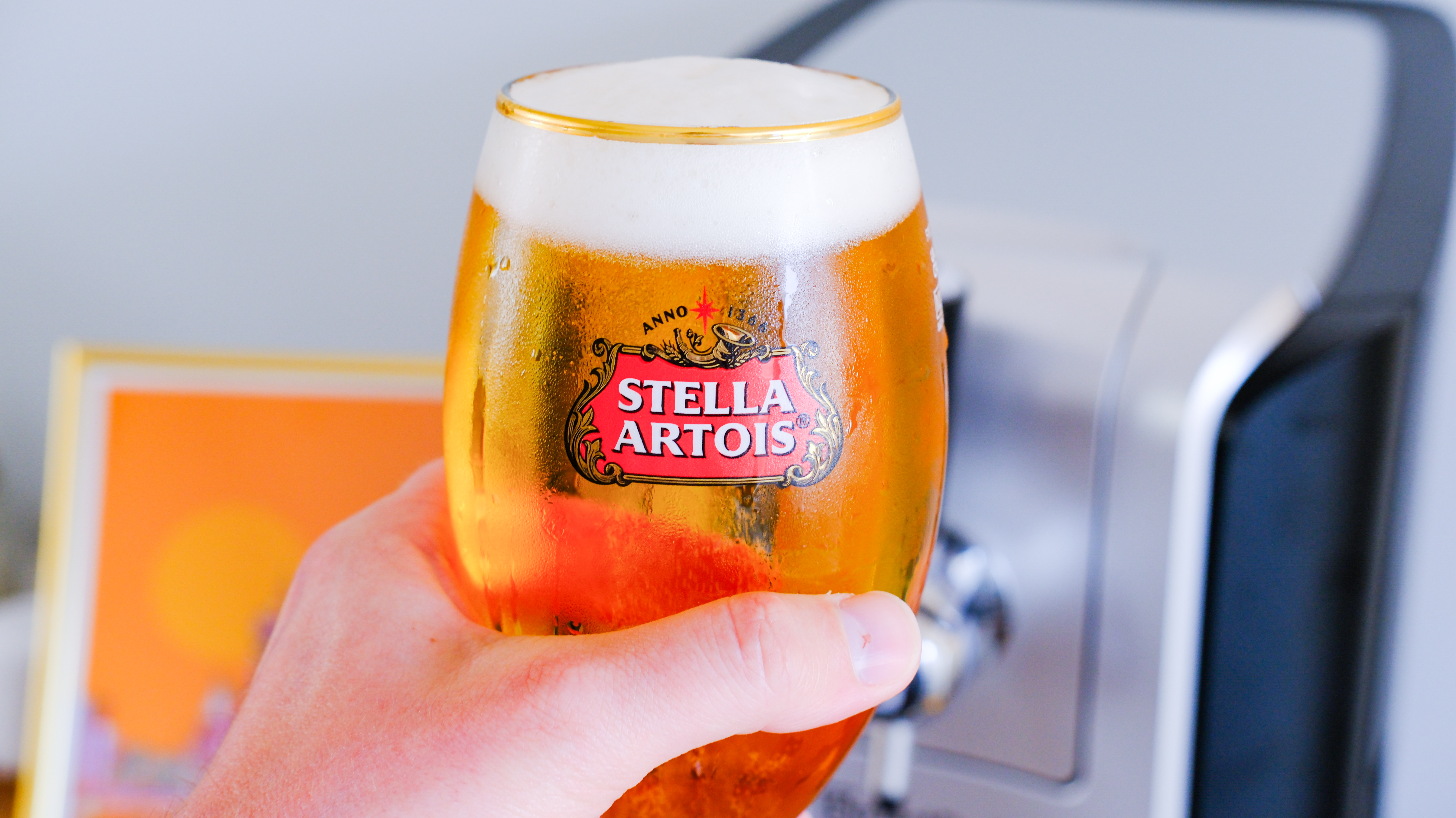 A pint of beer in hand poured on the PerfectDraft Beer machine