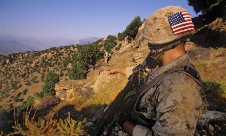 A U.S. Marine patrols in eastern Afghanistan: Newly published photos show a group of U.S. soldiers posing with the mutilated corpses of insurgent bombers.