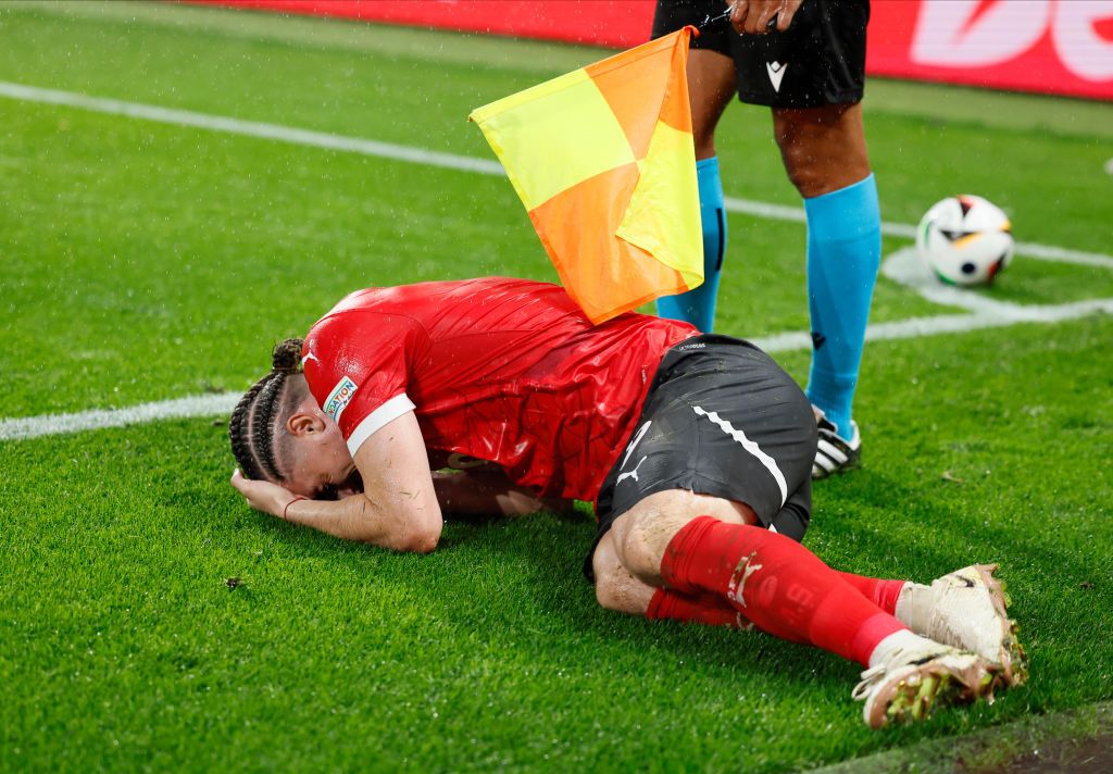 Marcel Sabitzer lies on the floor after being struck by an object during Turkey&#039;s Euro 2024 last-16 win over Austria