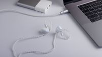 Activo Scoop wired earbuds in white on a white backdrop