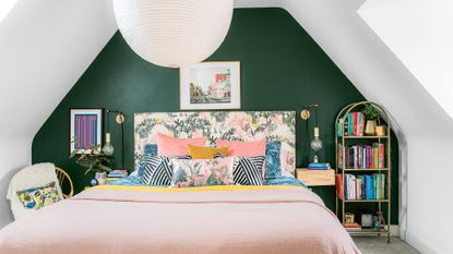 attic bedroom with green wall and book rack