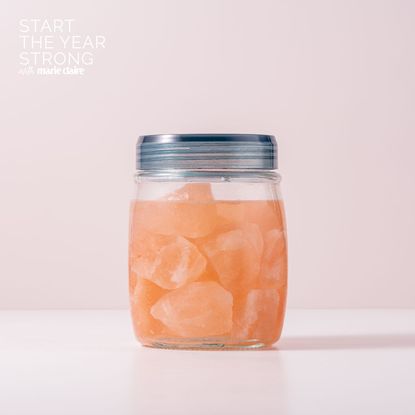 A jar of water with Himalayan salt rocks inside