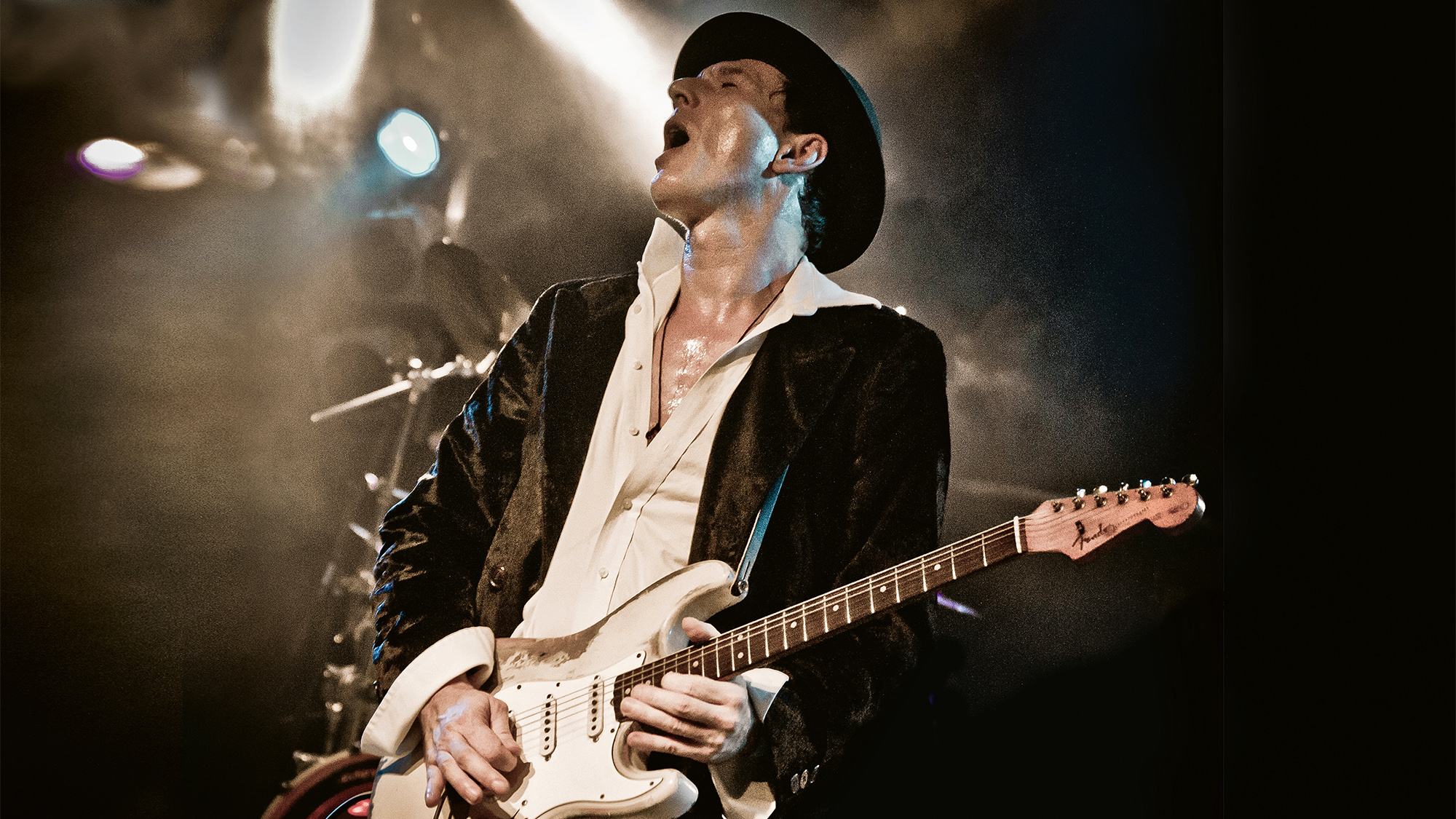 A photo of guitarist Marcus Demi onstage