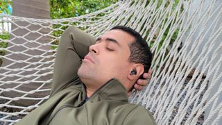 Man relaxing on hammock with Samsung Galaxy Buds 2