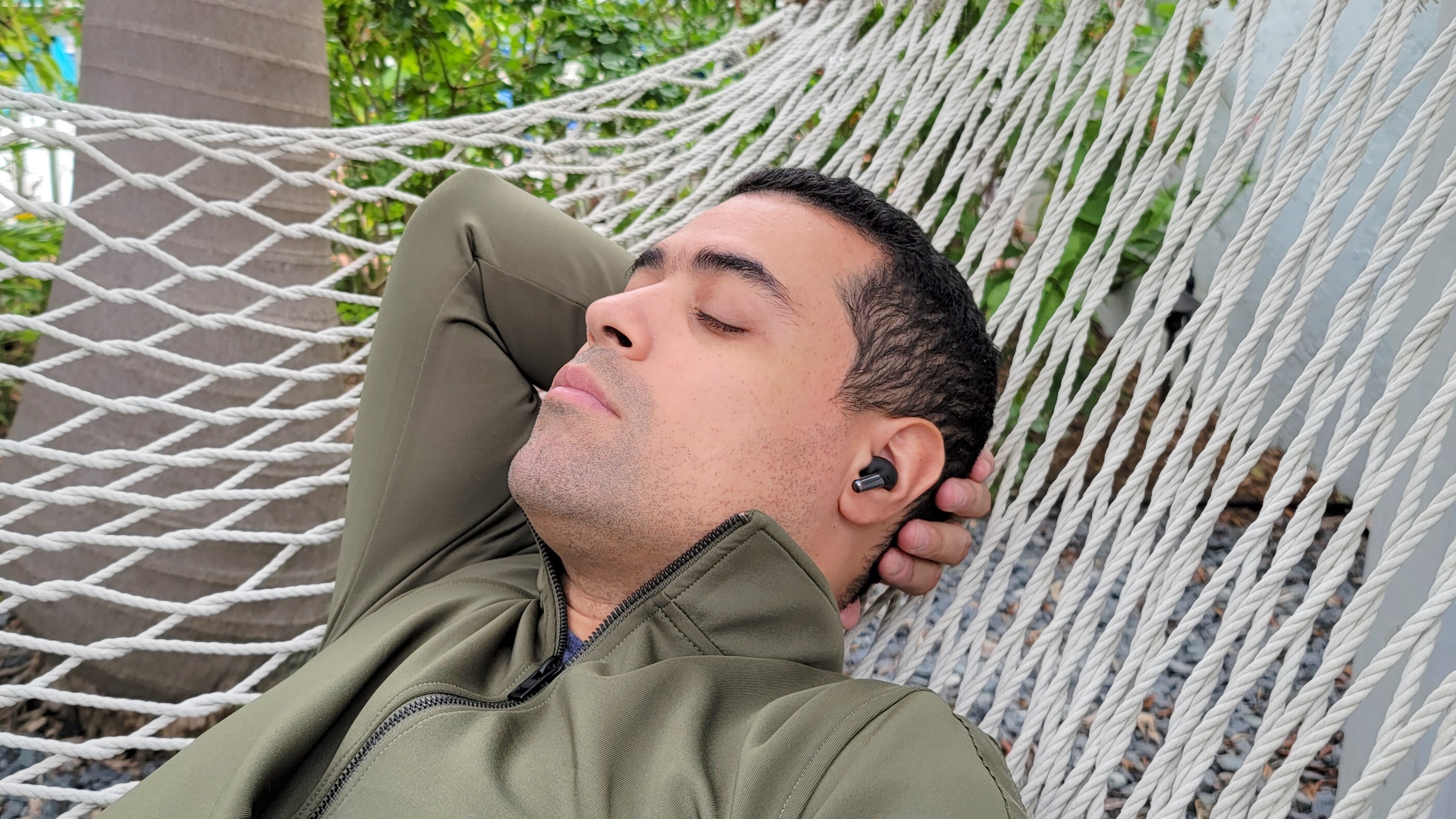 Man relaxing on hammock with Samsung Galaxy Buds 2