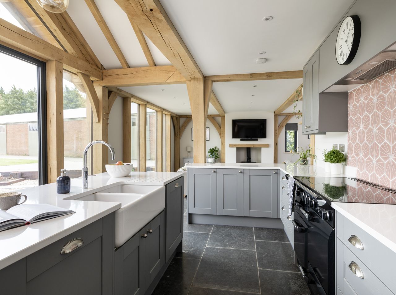 The white quartz surfaces from Belgravis Stone and pink splashback tiles from Porcelain Superstore provide a delicate balance.