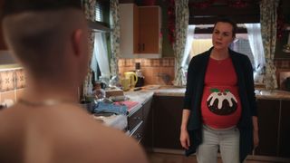 A very pregnant Mairead wearing a Christmas jumper with a festive pudding covering her baby bump while giving out to half-naked son Conor.