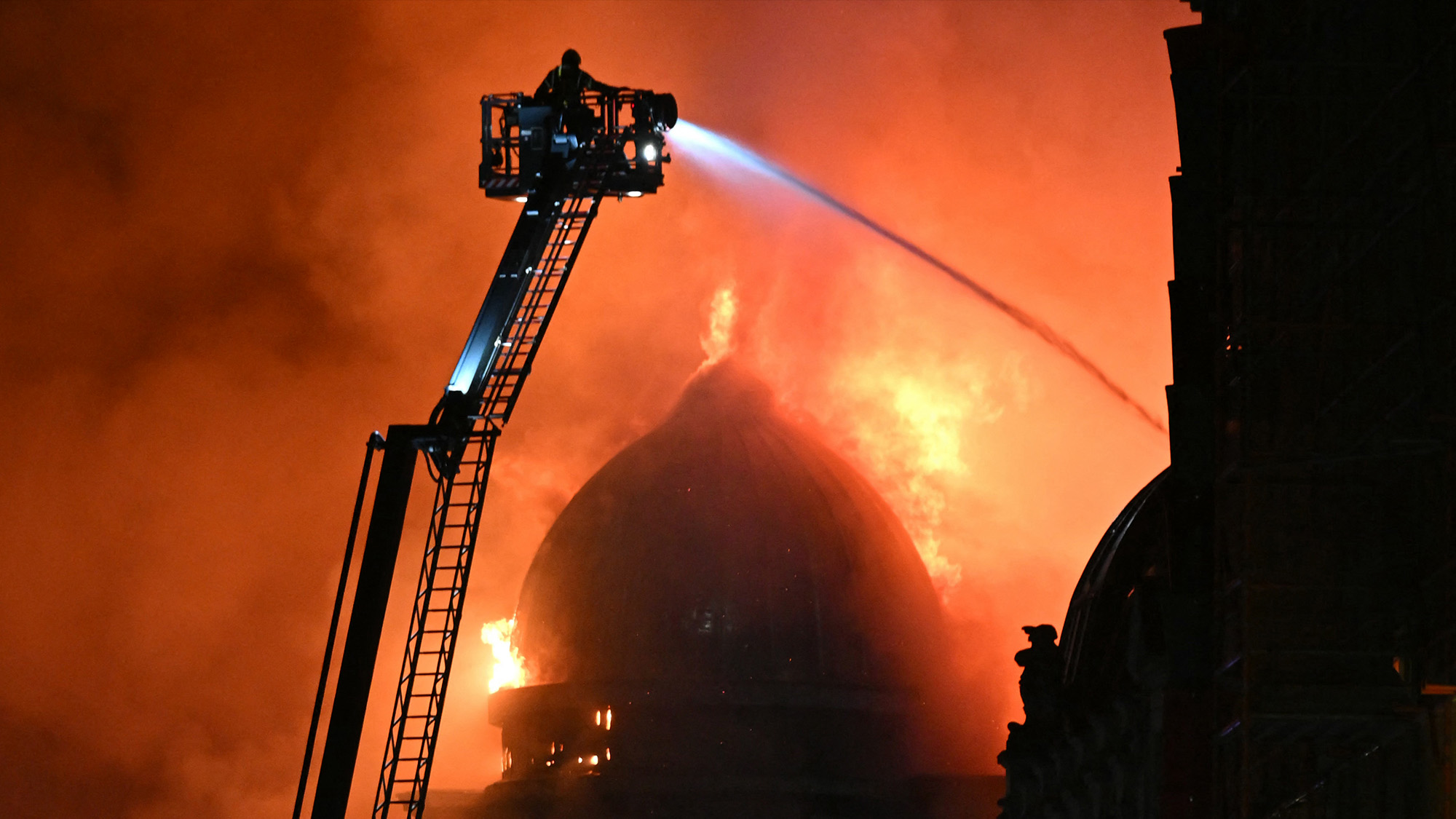 Firefighters work to control a large fire engulfing a historic building in Glasgow, Scotland