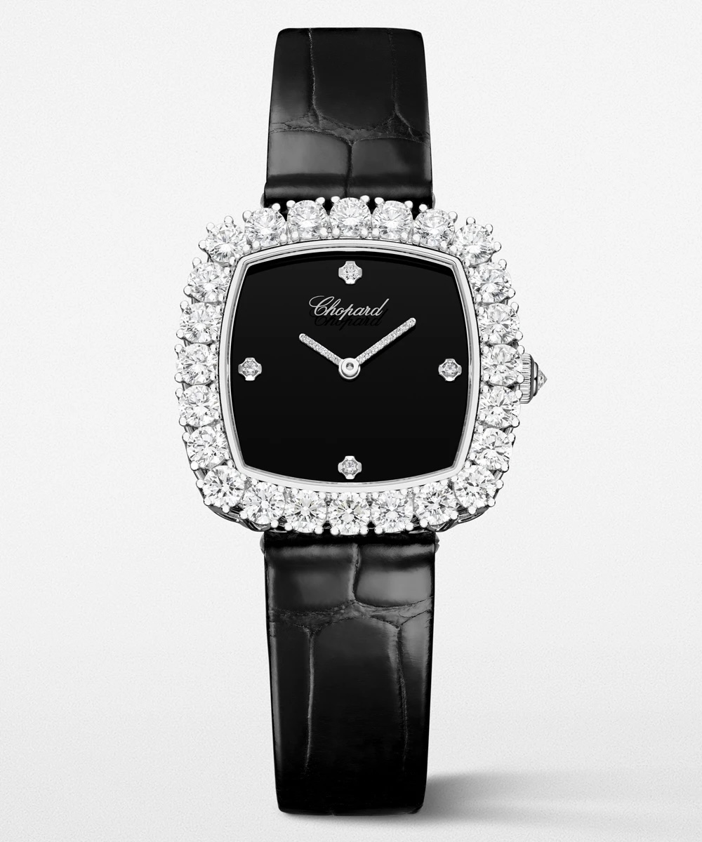 Black wrist watch with a cushion-case dial framed in diamonds