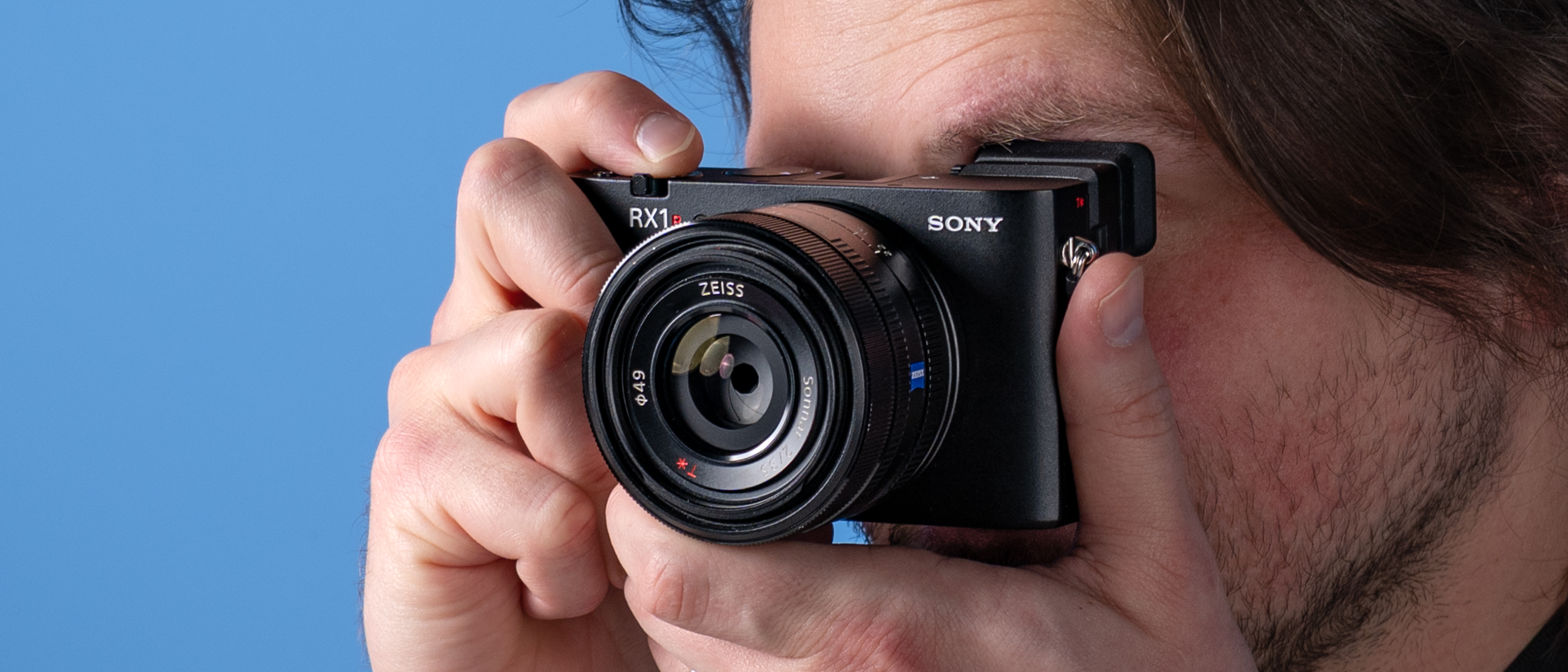 A photo of the Sony RX1R III in hand at a person&#039;s eye
